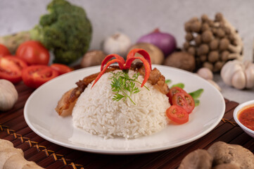 Pork belly fried on steamed rice on a plate.