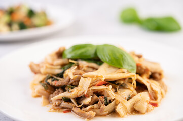 Bamboo shoot curry, add pork into a white dish.