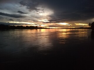 a dark sky over the water.dark sunset over lake
