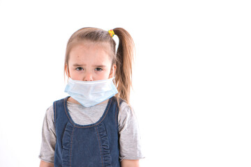 Portrait of a child on a white background, who wears a medical mask. Demonstration of medical equipment.