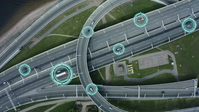Top down aerial drone view of autonomous self driving cars moving through city Spbd. traffic on junction. Artificial intelligence in automotive industry. contol concept
