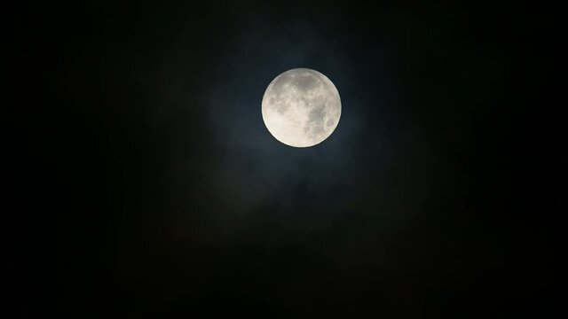 Moon with Dark Clouds, a footage of the moon with dark clouds around it and overlapping while moving down the frame as it was taken in the early hours of the morning.
