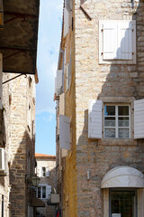 Fototapeta na wymiar Beautiful elements of old cities in Montenegro. Old town, street, houses windows.