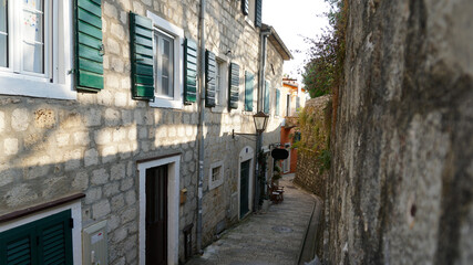 Fragments of the streets of the old city in Montenegro. Green blinds on the windows