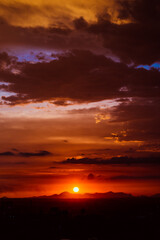 Fototapeta premium beautiful sunset with cloudy skies over the city and mountains 