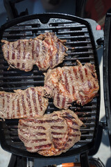 Grilled meat. Roasted piece of beef during cooking.