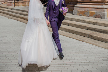 Fototapeta na wymiar groom with bride near ancient building in the city