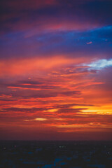 beautiful sunset with cloudy skies over the city and mountains 