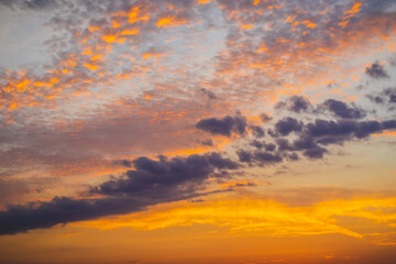 cloudy skies colored by a beautiful sunset