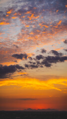 Fototapeta premium beautiful sunset with cloudy skies over the city and mountains 