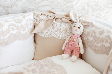 Fototapeta na wymiar Cute crochet bunny, pink pastel background, handmade rabbit, Easter rabbits, gift, childhood, baby toy