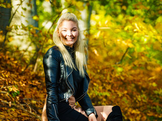 Fashion woman relaxing in autumn park