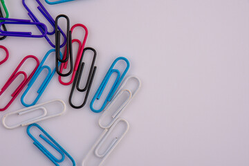 Colored paper clips on white background