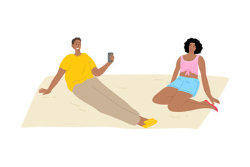 Fototapeta premium Man relaxing on grass and making photo of his girlfriend during summer festival
