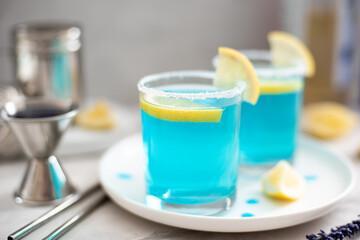 blue curacao cocktail with lemon slices in glasses