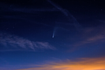 Fototapeta na wymiar Neowise comet on dark cloudy starry sky at dusk