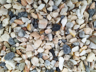 Raw rocks and minerals as natural stones background with crushed and rough material at a rough coast or rocky beach show nuggets and sandstones in harmonic pastel colors