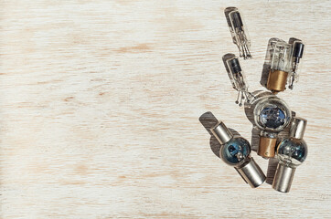 small vacuum glass electronic retro light bulb on the wooden background