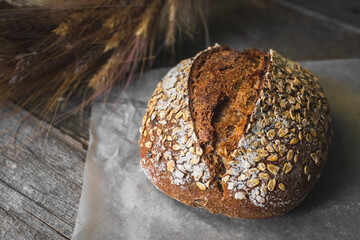 loaf of bread with sesame seeds on wooden background