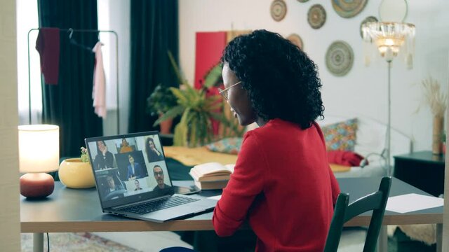 Online learning, distance eductaion, remote studying concept. Self-isolating african lady is participating in a video conference