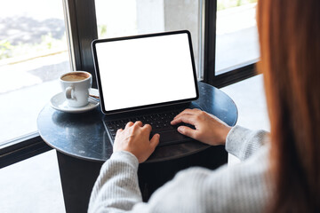 Mockup image of a woman using and typing on tablet keyboard with blank white desktop screen as a computer pc on the table
