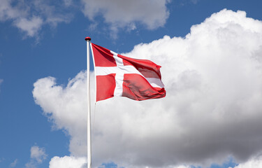 Danish flag with blue sky and clouds
