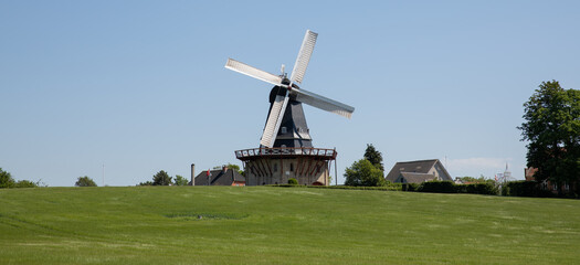 old mill in denmark with yellow and black