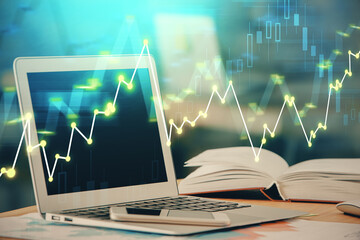 Forex graph hologram on table with computer background. Double exposure. Concept of financial markets.