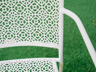 White chair stencil in green field.