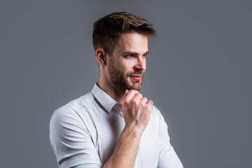 handsome man in white shirt. indoor portrait of sexy european businessman. confident and calm. handsome casual man standing with beard and bristle. cheerful and stylish