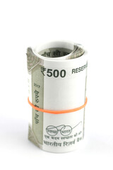 Indian currency notes of various denominations. A bundle of 500 Rupees notes tied with a rubber band.