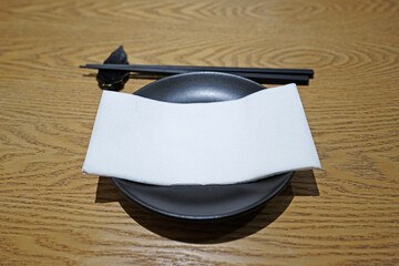 Close up black Asian cutlery setting on wooden table