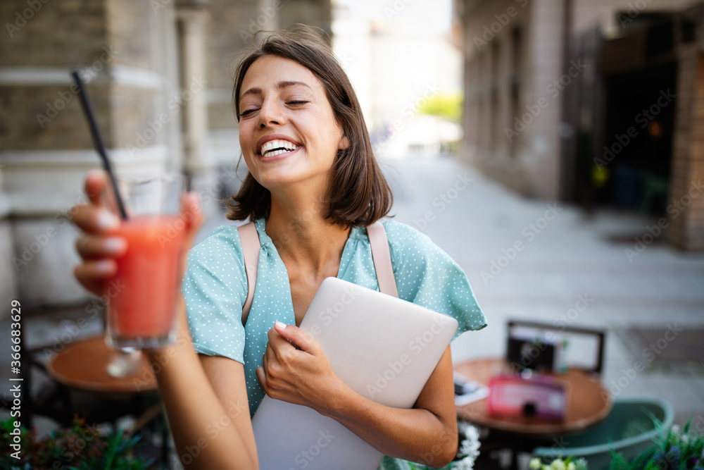 Wall mural Beautiful young happy cheerful woman enjoying her time and freedom