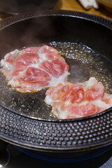 Pork meat in Sukiyaki pan, Japanese hot pot