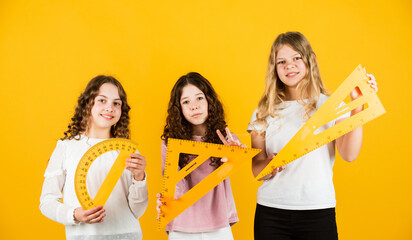 Smart and confident. exact sciences. three girls with protractor and triangle ruler. back to...