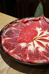 Close up dish of fresh and raw sliced Wagyu beef steak