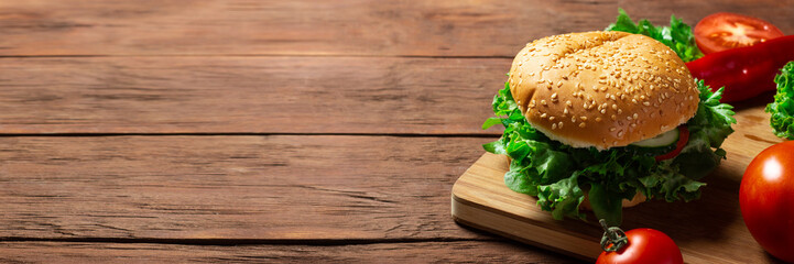 Ingredients for making a burger. Burger on a dark wooden background. Banner