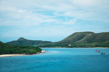 Fototapeta premium Aerial view of the island with blue sky over on the beach background. Tropical colorful sand from the landscape sea. The ocean holiday summer vacation at Koh Samae San, Sattahip, Chon Buri, Thailand.