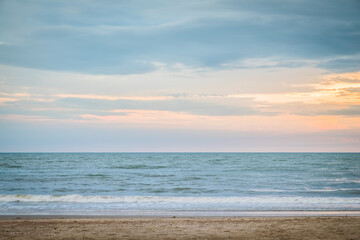 Beautiful golden sunset with blue sky over the horizon on the beach background. Tropical twilight colorful sunrise from the landscape sea. Summer vacation concept.