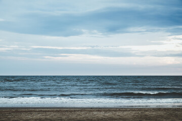 Beautiful beach sea wave and blue sky for vacations in Thailand. The coastal scene along the coast.