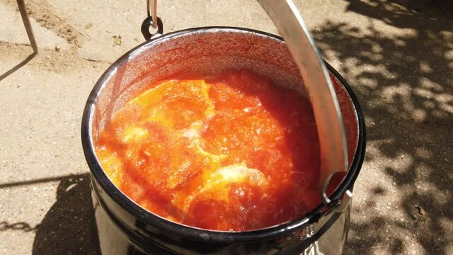 Hungarien fish soup with paprika and onion and fish.