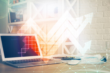 Computer on desktop with point up arrows hologram. Double exposure. Concept of success.