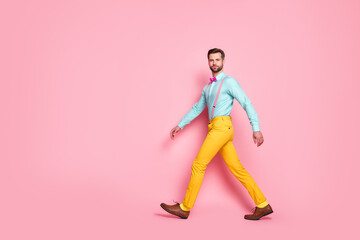 Full length body size profile side view of his he nice attractive elegant brandy funky well-dressed brunet guy artist strolling corporate event party isolated over pink pastel color background