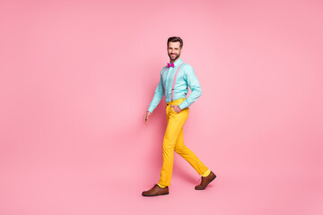 Full length body size view of his he nice attractive elegant fashionable content cheerful cheery bright bearded guy artist walking stage scene mc isolated over pink pastel color background