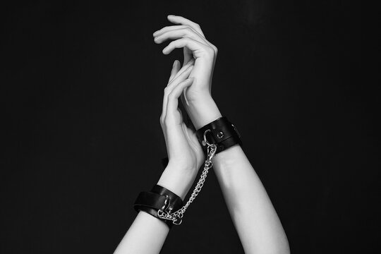 female hands in handcuffs. slave Woman in dark