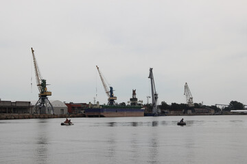 Port terminal. Heavy lifting cranes stand in a row.