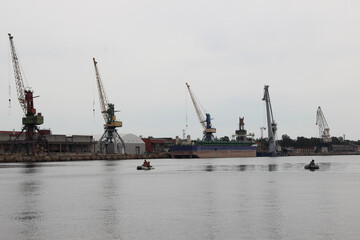Port terminal. Heavy lifting cranes stand in a row.