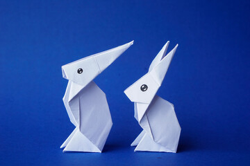 Simple flat lay out. two White rabbits paper origami on clear background with copy space concept