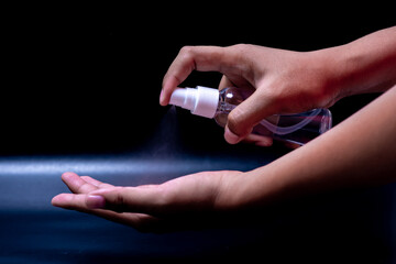 The spray in the hands shows the destruction of the germs of Covid-19./Spray at hand
