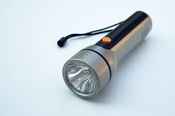 Large plastic flashlight in silver color on a white background